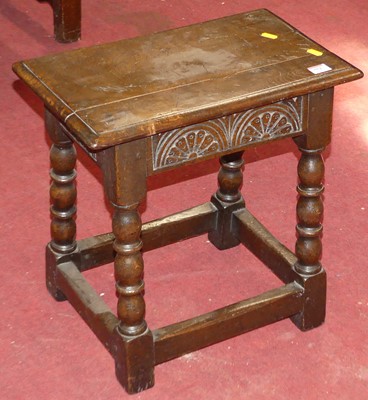 Lot 552 - An antique oak joint stool with rosette carved...