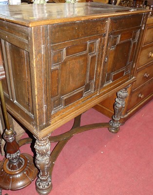 Lot 681 - An antique joined oak cupboard on stand, the...