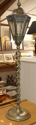 Lot 558 - A brass table lamp in the form of a lantern on...