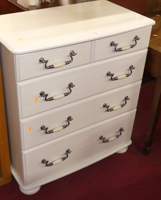 Lot 560 - A modern white laminate finished chest of two...