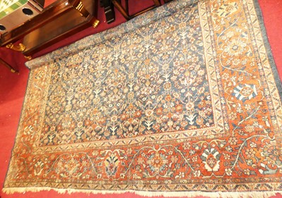 Lot 694 - A Persian woollen blue ground herat carpet,...