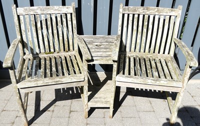 Lot 715 - A pair of co-joined teak garden seats, width...