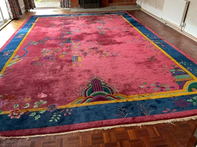 Lot 705 - A large machine woven woollen carpet,...
