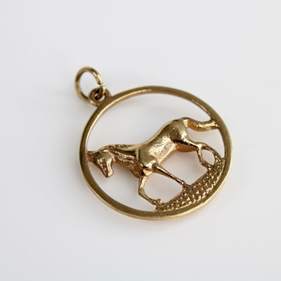 Lot 362 - A 9ct gold pendant as a horse within a ringed...