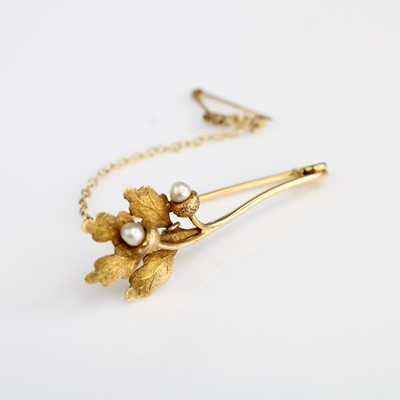 Lot 365 - A yellow metal and seed pearl set bar brooch,...