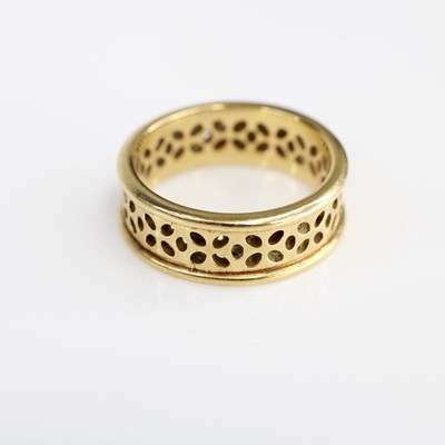 Lot 342 - A pierced yellow metal band ring, unmarked but...