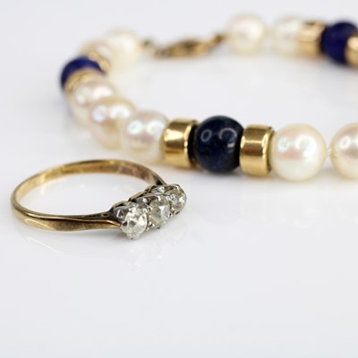 Lot 351 - A yellow metal diamond three stone ring, the...