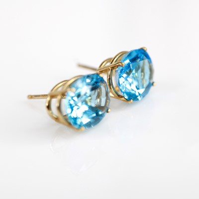 Lot 2134 - A pair of yellow metal blue topaz set stud...