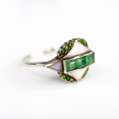 Lot 2142 - A white metal dress ring, featuring three...