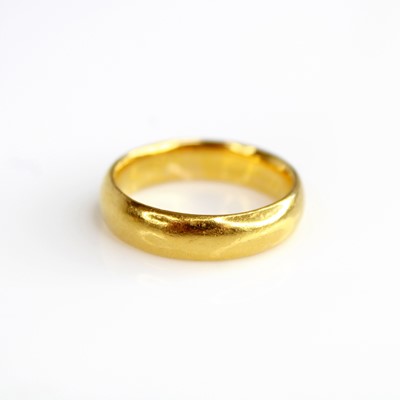 Lot 2151 - A 22ct gold 5.2mm court shaped wedding band,...