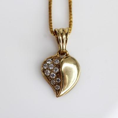 Lot 2140 - A 9ct diamond set heart shaped pendant, one...