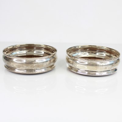 Lot 308 - A pair of Elizabeth II silver bottle coasters,...