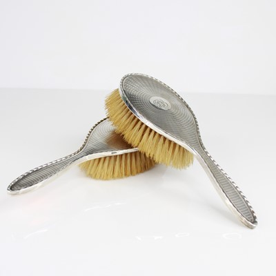 Lot 311 - A George V silver-backed four-piece dressing...