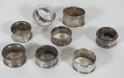 Lot 337 - A collection of eight silver napkin rings, to...