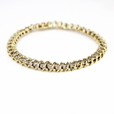 Lot 141 - A yellow metal diamond line bracelet,...