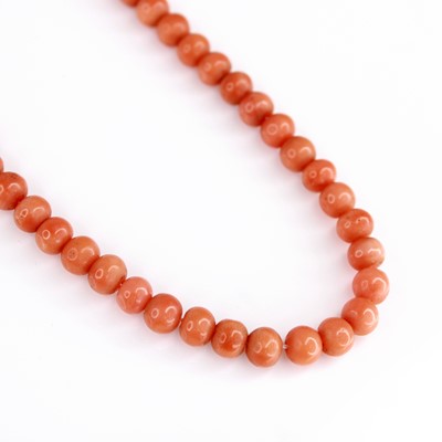 Lot 2100 - A beaded coral necklace, each bead approx 5 to...