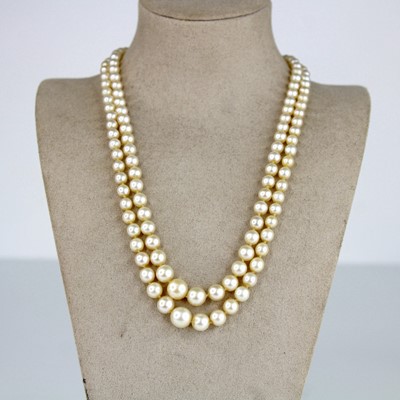 Lot 2175 - A two-row pearl necklace comprising 63 and 69...