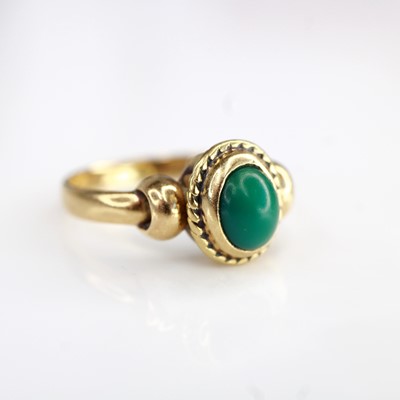 Lot 2194 - A yellow metal and cabochon green hardstone...