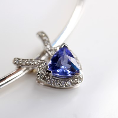 Lot 2219 - An 18ct gold tanzanite and diamond pendant,...