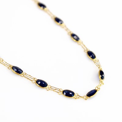Lot 2089 - A contemporary yellow metal and sapphire set...