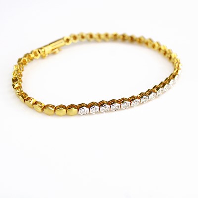 Lot 2103 - An 18ct gold diamond set bracelet, arranged as...