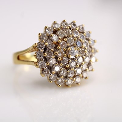 Lot 2116 - An 18ct gold diamond cluster ring, arranged as...