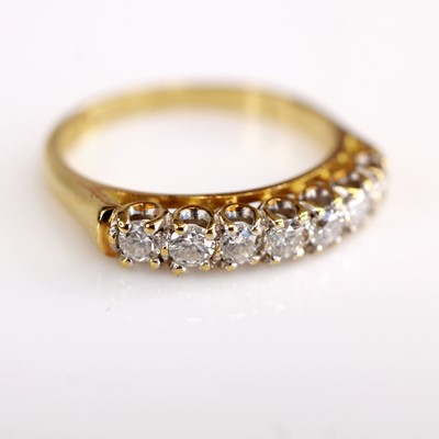 Lot 2128 - An 18ct gold diamond half eternity ring,...