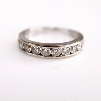 Lot 2189 - An 18ct white gold diamond half eternity ring,...