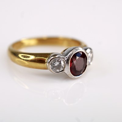 Lot 2196 - An 18ct gold ruby and diamond three-stone ring,...