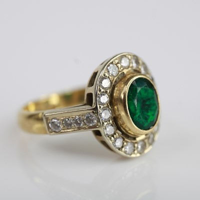 Lot 2213 - A yellow metal, emerald and diamond oval...