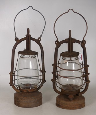 Lot 40 - Two metal and glass paraffin storm lanterns...