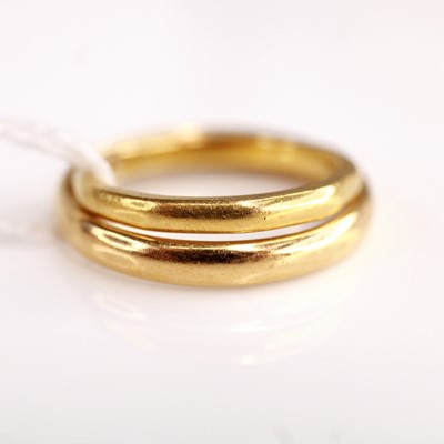 Lot 345 - A 22ct gold wedding band, size N; together...