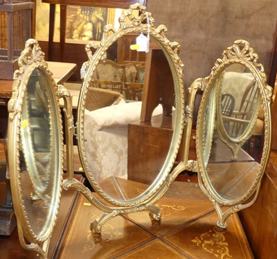 Lot 661 - A gilt metal triptych dressing table mirror;...
