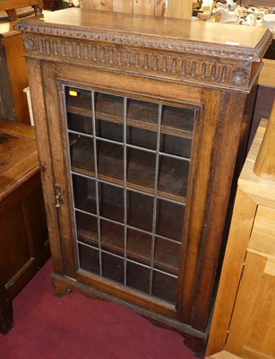 Lot 609 - An early 20th century oak single door lead...