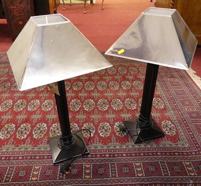 Lot 610 - A pair of contemporary ebonised column table...