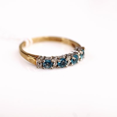 Lot 382 - A 9ct gold blue topaz half hoop ring, the four...
