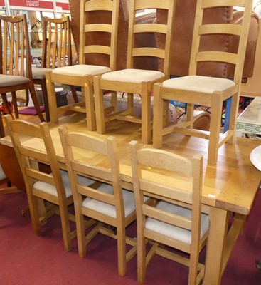 Lot 675 - A contemporary blond joined oak dining suite,...