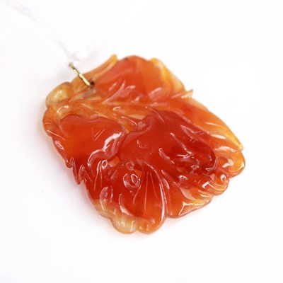 Lot 388 - A Chinese carved orange nephrite pendant, 38 x...