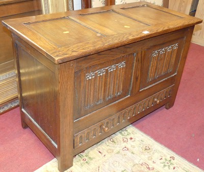 Lot 711 - An oak linenfold three-panel hinge topped mule...