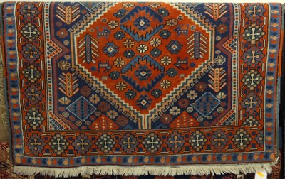 Lot 723 - A Persian woollen red, blue and cream ground...