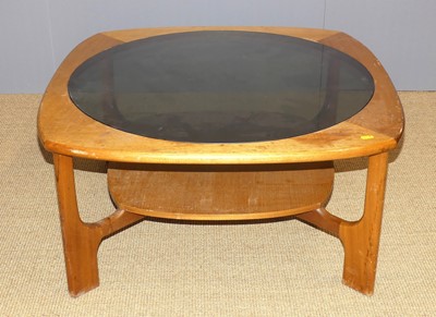 Lot 676 - A 1970s teak and smoky glass inset coffee...