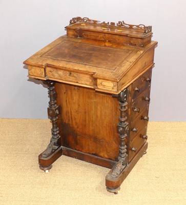 Lot 657 - A mid-Victorian walnut davenport, the hinged...