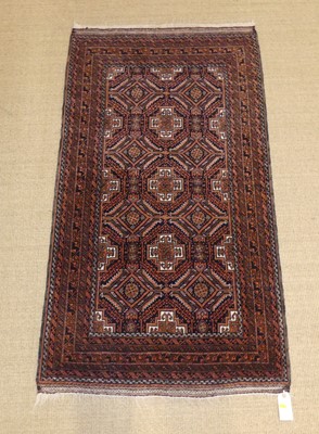 Lot 749 - A Persian Baluch rug, with bronze ground and...