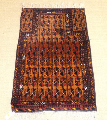 Lot 751 - A Persian woollen Baluch prayer rug, with...