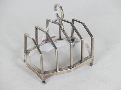 Lot 377 - An Art Deco silver toast-rack, of angular form...