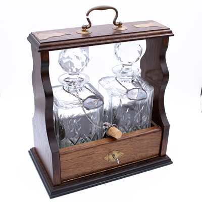 Lot 29 - A contemporary mahogany tantalus, surmounted...