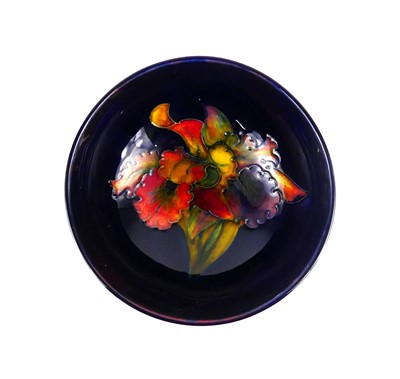 Lot 217 - A Moorcroft Blue Flambé Orchid pattern pottery...