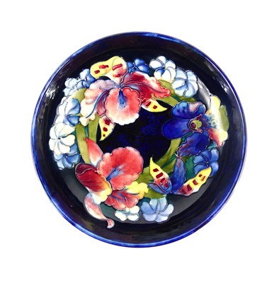 Lot 223 - A Moorcroft Iris Orchid pattern pottery footed...