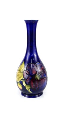 Lot 202 - A large Moorcroft Anemone pattern bottle...