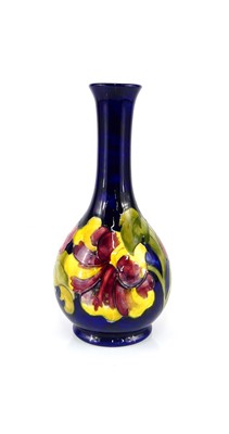 Lot 219 - A Moorcroft Hibiscus pattern pottery bottle...